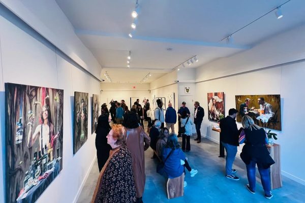 a group of people in a room with art on the wall