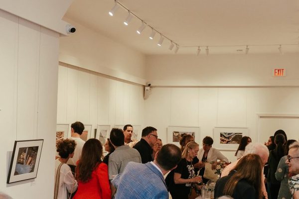 a group of people in a room with art